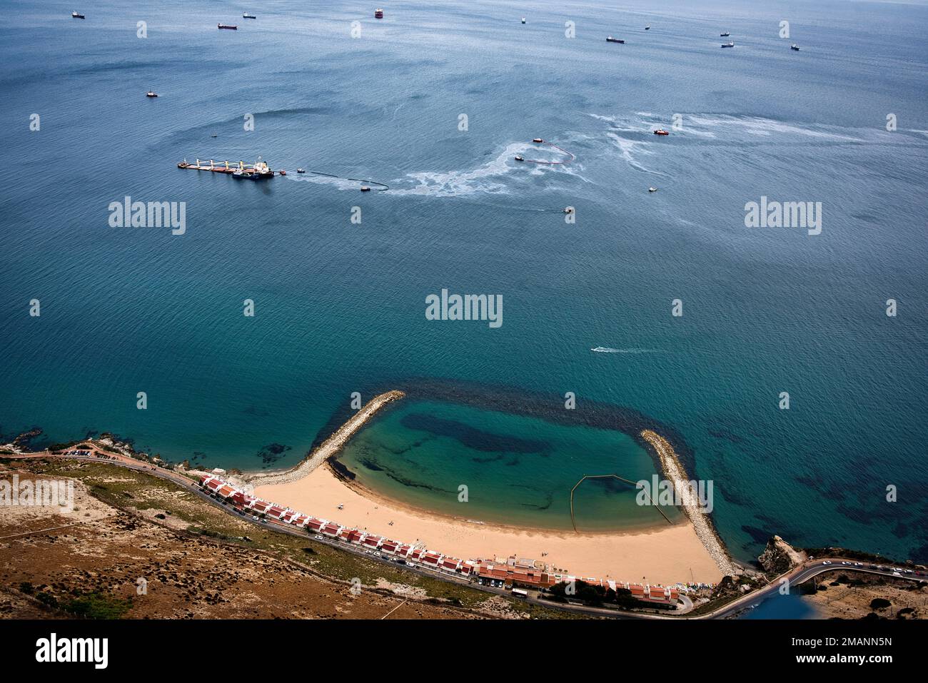 Tug boats work to control spilled oil from the Tuvaluregistered OS 35