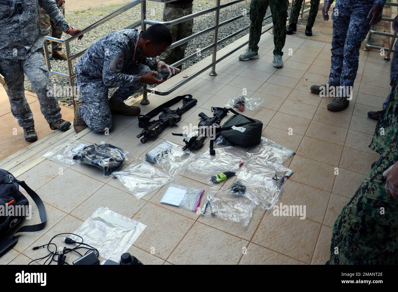 A member of the Philippine Coast Guard Special Operations Force photographs notional contraband during a sensitive site exploitation demonstration with 1st Special Forces Group (Airborne) Green Berets on June 1, 2022, near Puerto Princesa, Palawan. This engagement provided an opportunity for the Philippine National Police, Philippine Coast Guard Special Operations Force and U.S. Green Berets to exchange tactics, techniques and procedures with each other in an effort to enhance interoperability while sharing new ideas for maritime operations. Other TTP’s exchanged during the engagement included Stock Photo
