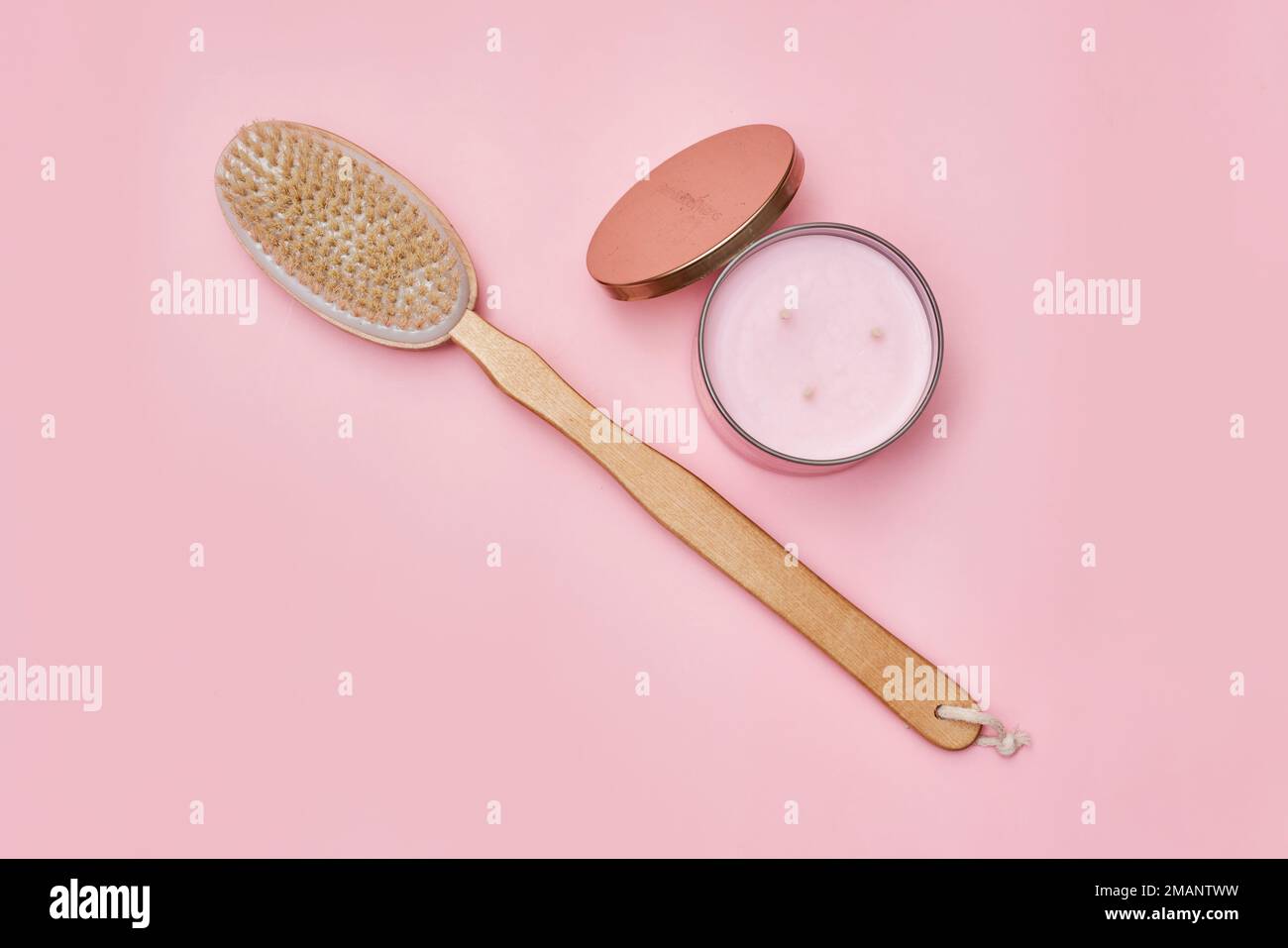an oval brush and a round metal container on a pink background the brushes are made from natural wood, which can be used for Stock Photo