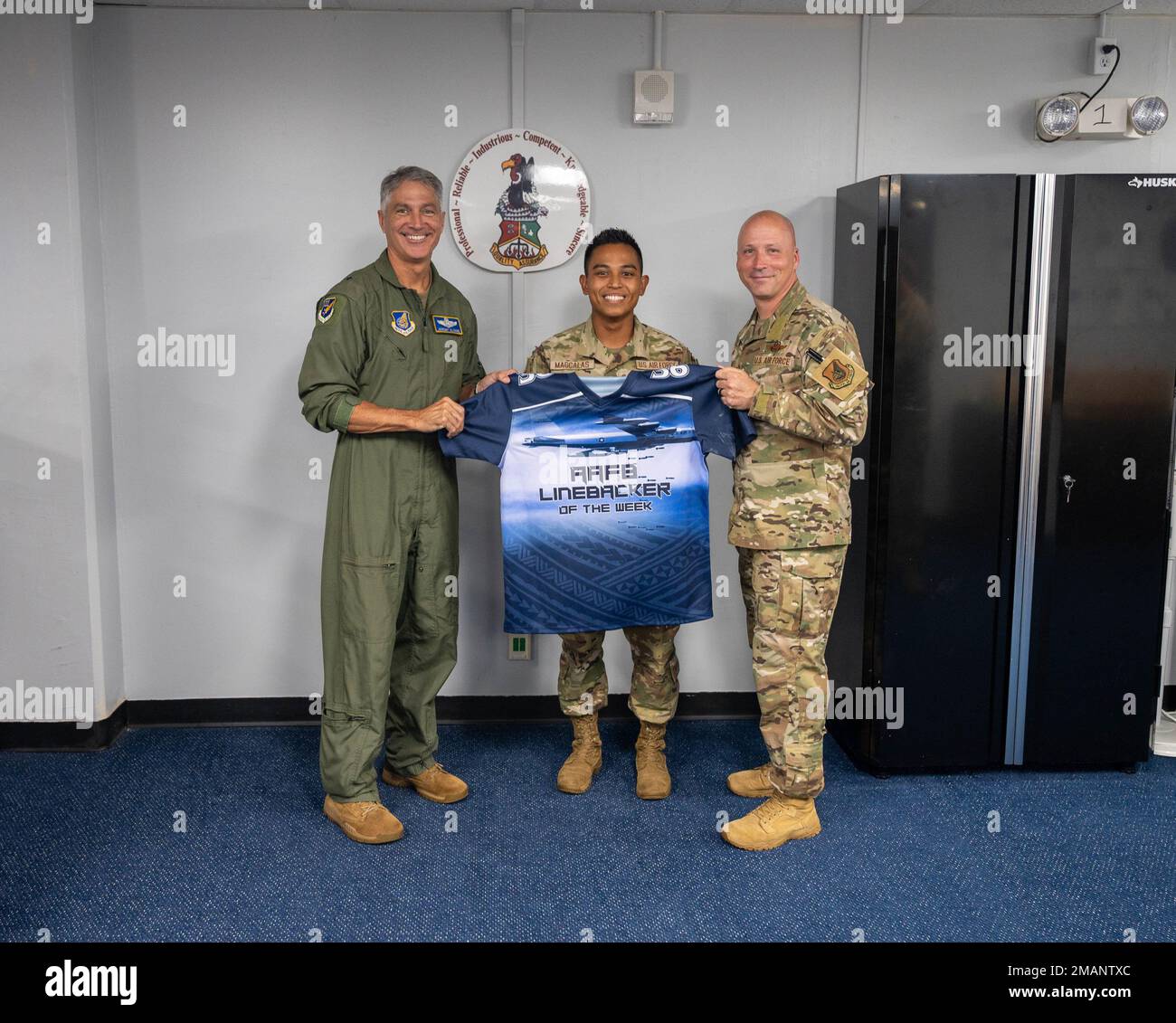 . Air Force Staff Sgt. Calvin Klein Magcalas, quality assurance  inspector with the 36th Maintenance Group, receives the Linebacker of the  Week Award from . Air Force Brig. Gen. Jeremy Sloane, 36th