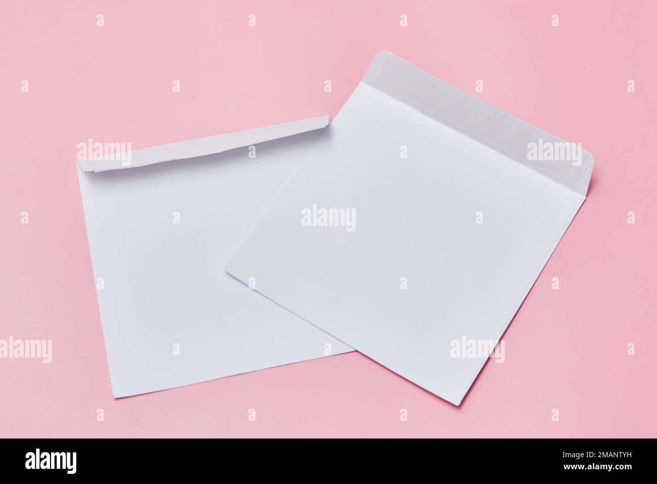 two white envelopes on a pink background with copy space for your text or message, top view stock photo Stock Photo