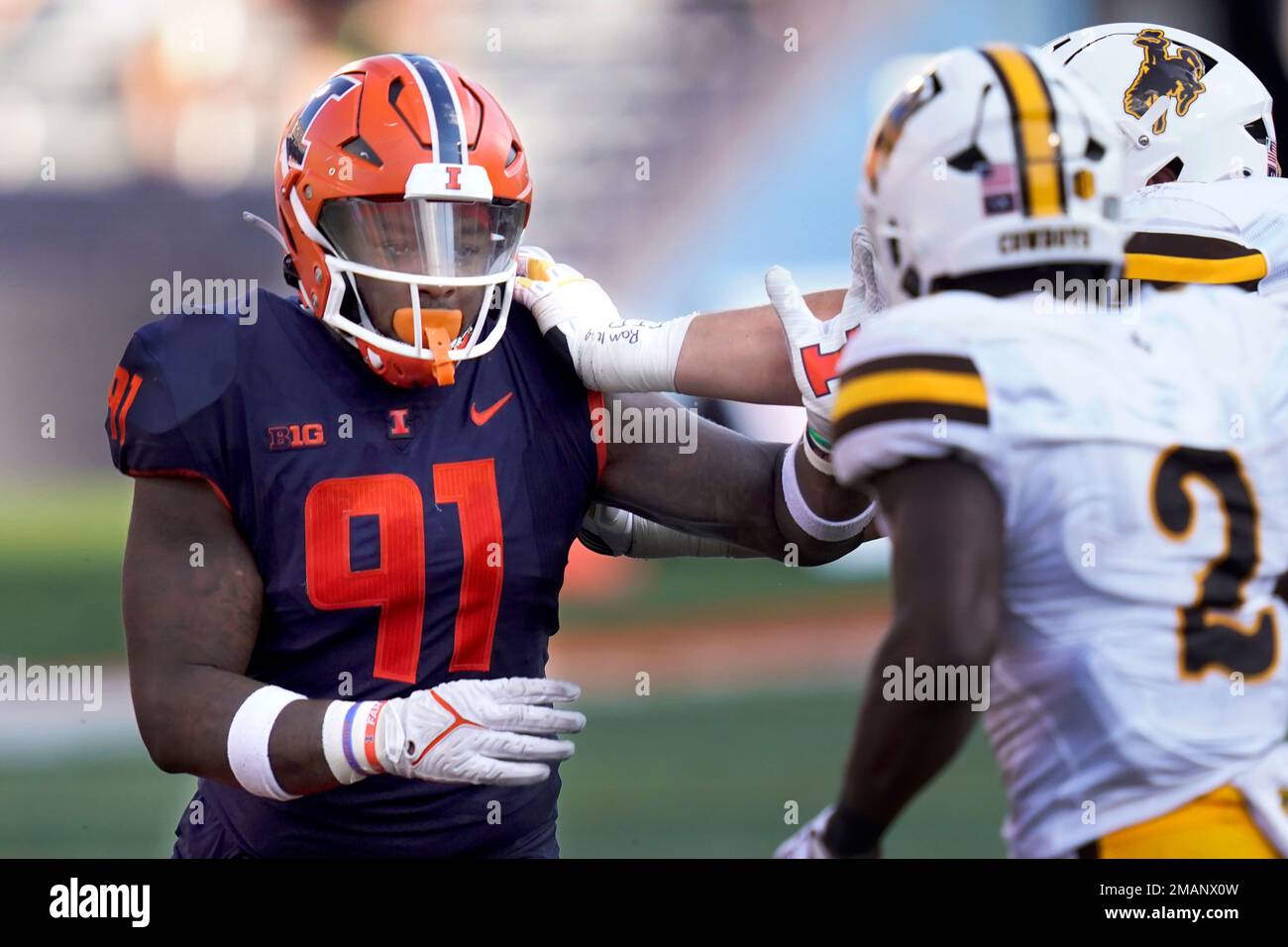 Illinois defensive lineman Jamal Woods fights off a Wyoming block