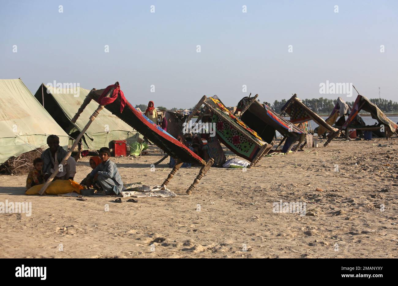 Displaced families who fled their flood-hit homes take refuge in ...