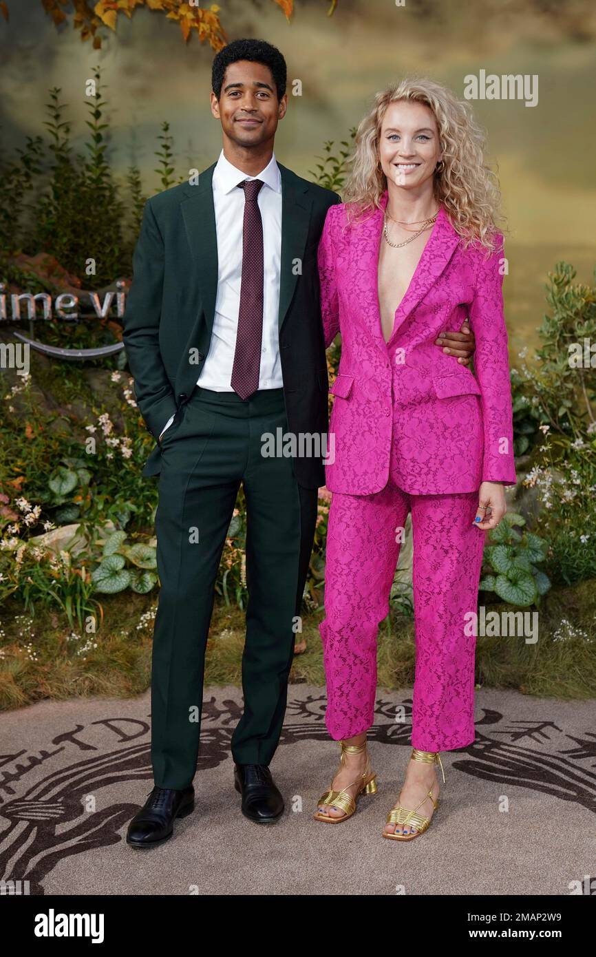 Alfred Enoch, left, and Mona Godfrey pose for photographers upon their  arrival for the world premiere of the TV Series 'The Lord of the Rings: The  Rings of Power' in London, Tuesday,