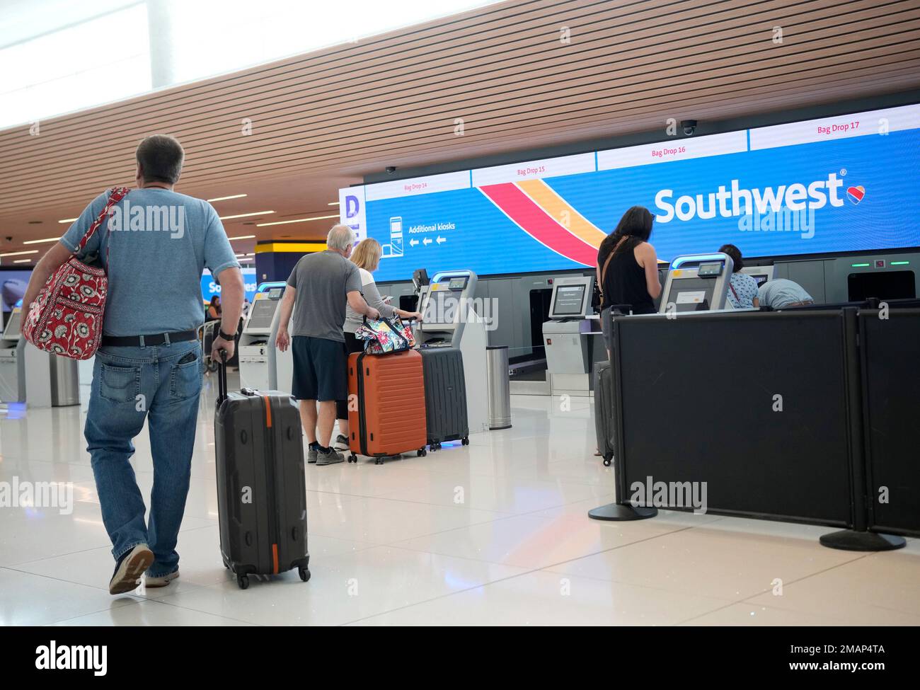 Traveler approaches the selfcheckin kiosks for Southwest Airlines in