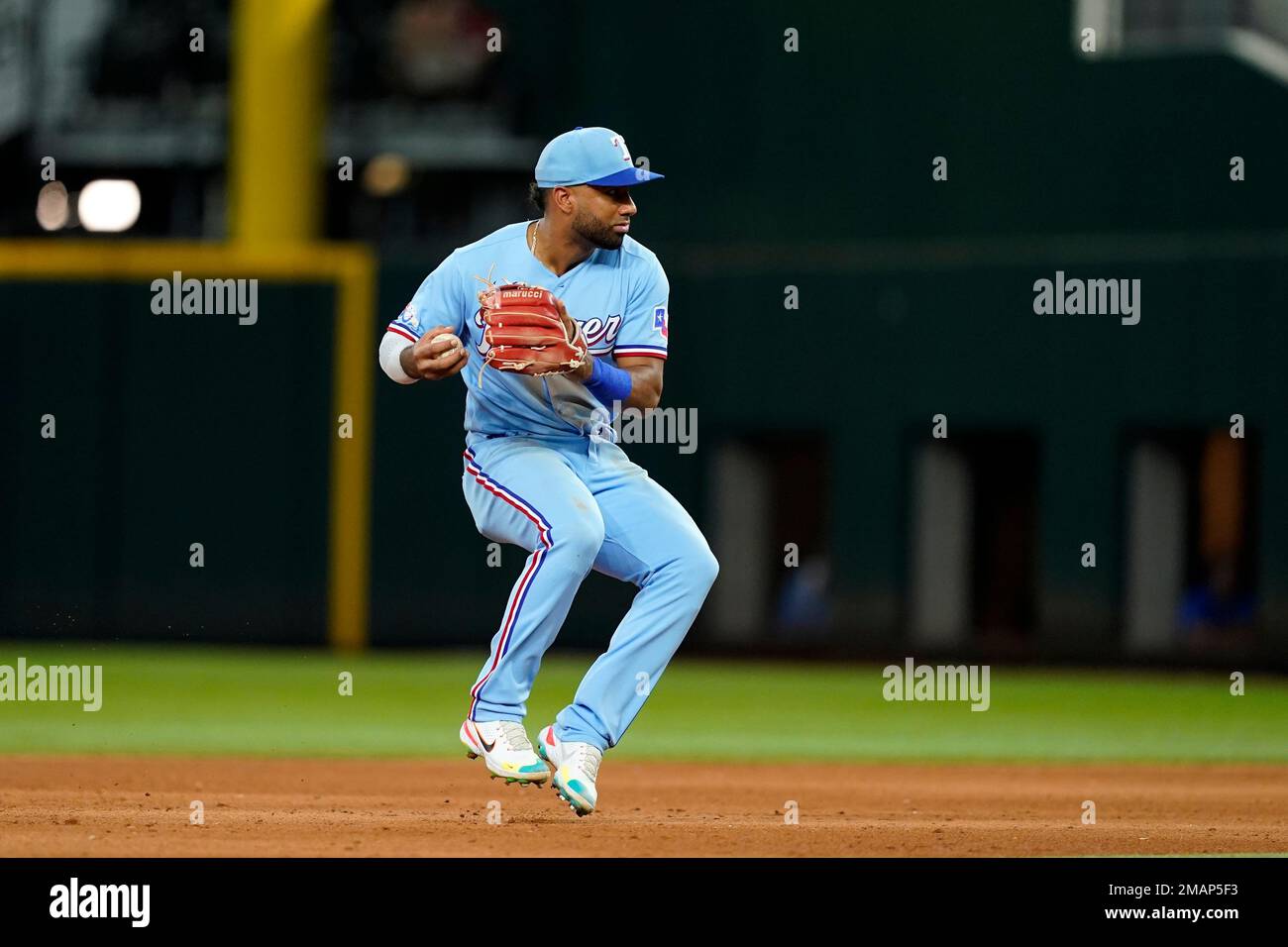 Texas Rangers' Ezequiel Duran throws to first during a baseball game