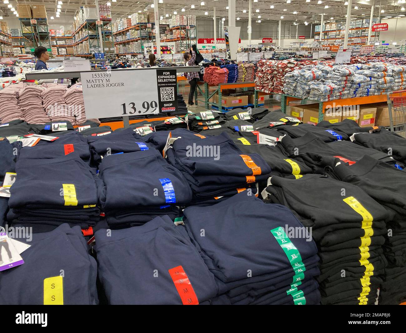 Hold For Biz—Clothing sits on display on tables for shoppers in a ...