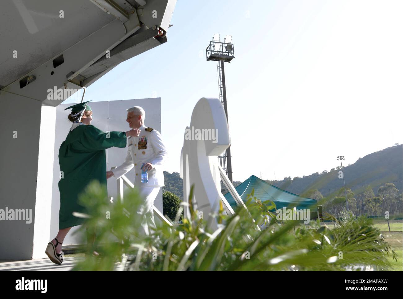 220602-N-IE405-1723 POZZUOLI, Italy (June 2, 2022) Naples Middle High School graduating student Sydney Stewart prepares to hug her father and Commanding Officer of U.S. Naval Support Activity (NSA) Naples Capt. James Stewart during the Class of 2022 graduation ceremony NSA Naples' Carney Park in Pozzuoli, Italy, June 2, 2022. NSA Naples is an operational ashore base that enables U.S., allied, and partner nation forces to be where they are needed, when they are needed to ensure security and stability in the European, African, and Central Command areas of responsibility. Stock Photo