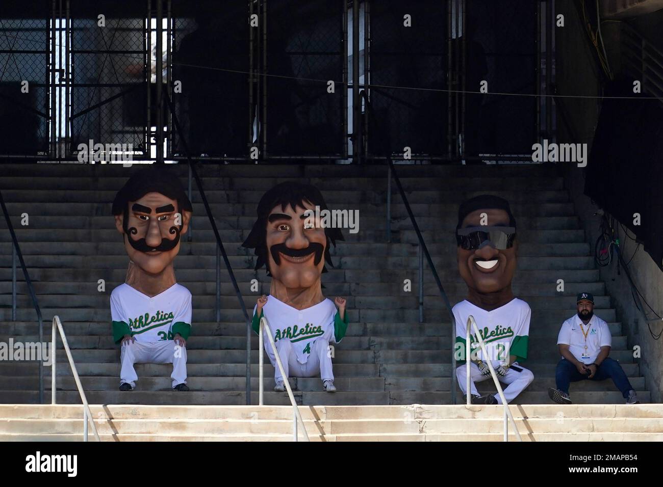Mascots representing former Oakland Athletics Rollie Fingers, from left,  Dennis Eckersley and Rickey Henderson wait before racing during a baseball  game between the Athletics and the New York Yankees in Oakland, Calif.