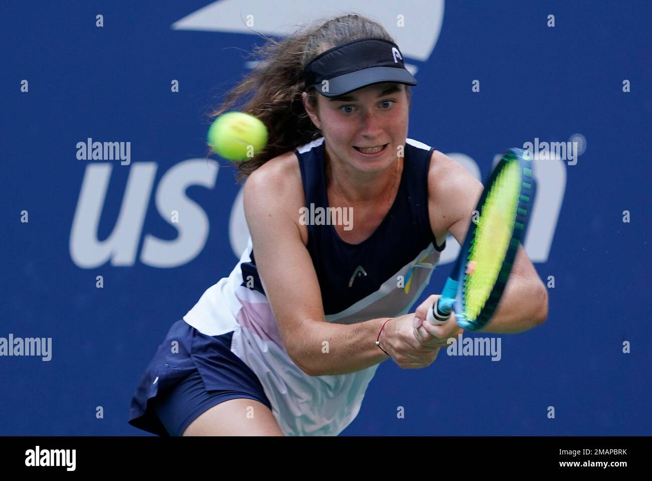 Daria Snigur, of Ukraine, returns a shot to Simona Halep, of Romania, during the first round of the US Open tennis championships, Monday, Aug