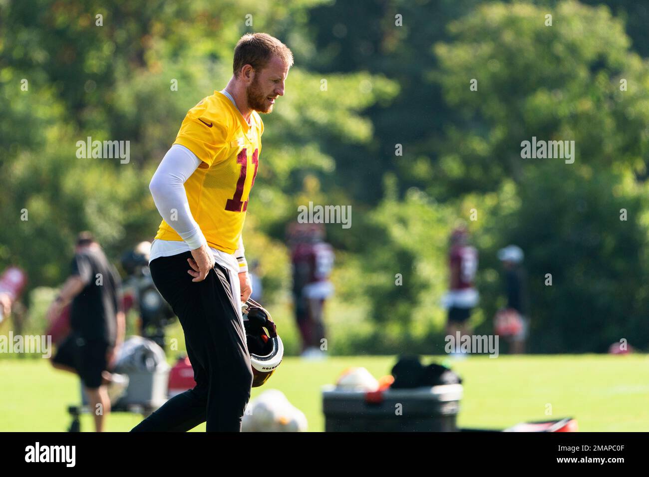 Washington Commanders quarterback Carson Wentz, walks on the field ...