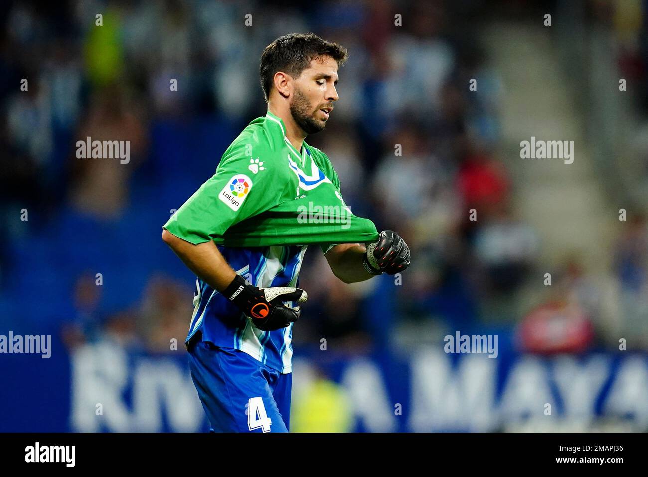 Espanyol s Leandro Cabrera puts on the goalkeeper s jersey to replace teammate goalkeeper Benjamin Lecomte after he saw a red card during a Spanish La Liga soccer match between Espanyol and Real Madri...
