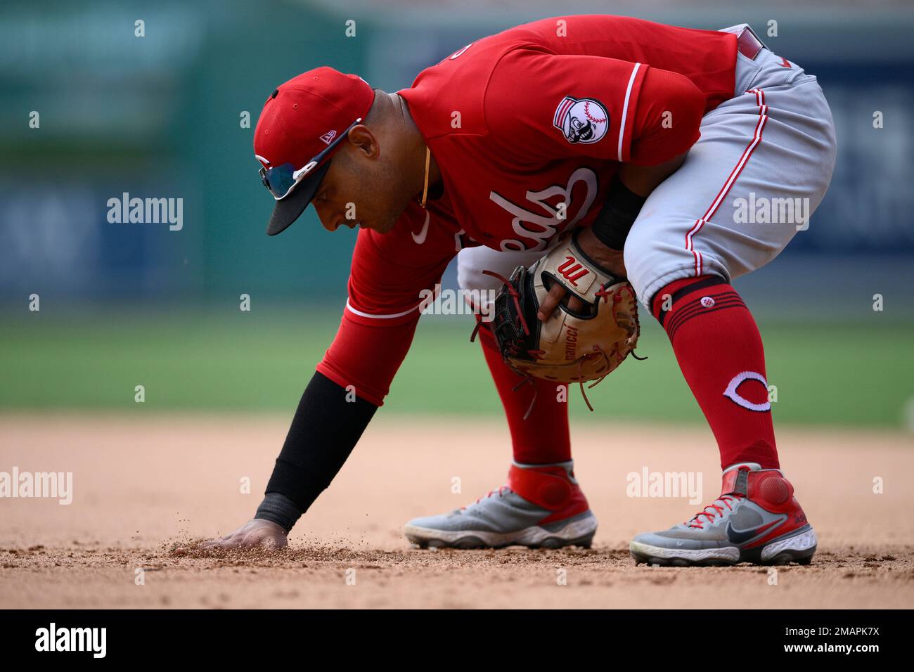 Cincinnati Reds first baseman Donovan Solano rubs the infield dirt by first  base during the eighth inning of a baseball game against the Washington  Nationals, Sunday, Aug. 28, 2022, in Washington. The