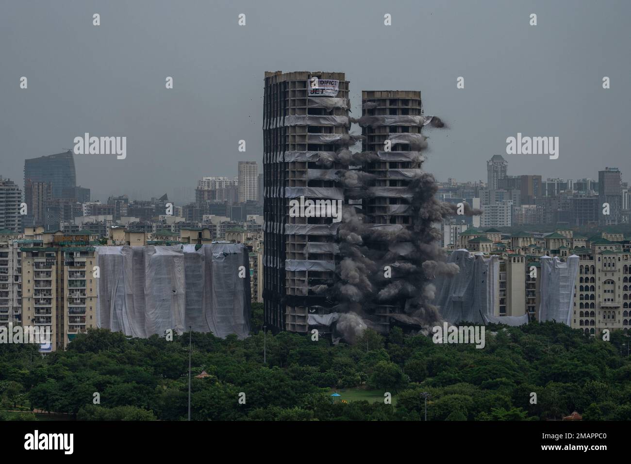 Explosives are detonated to demolish twin high-rise apartment towers in ...