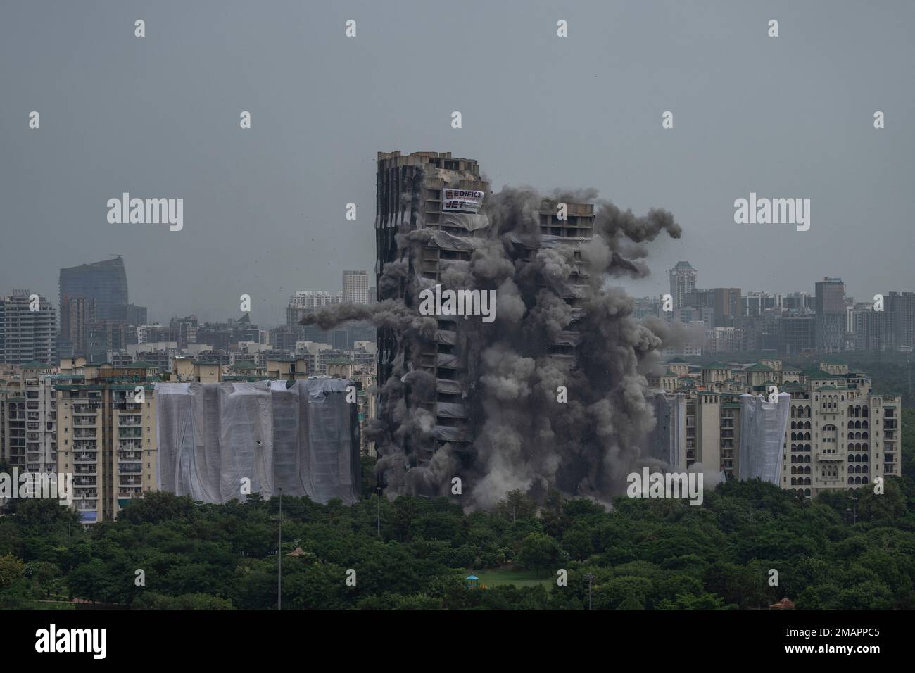Explosives are detonated to demolish twin high-rise apartment towers in ...