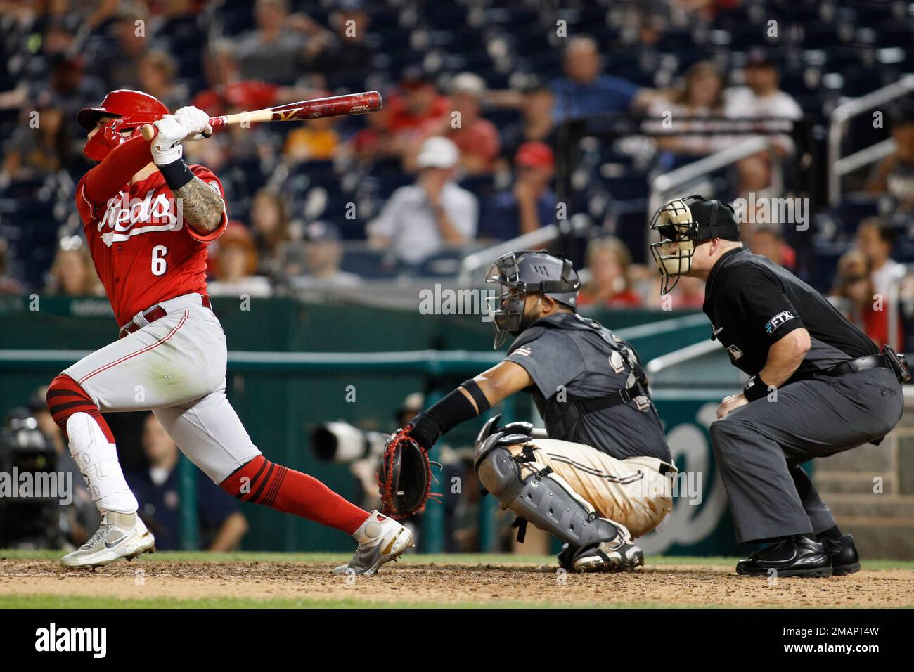 Cincinnati Reds' Jonathan India, left, receives the Major League Baseball  Rookie of the Year Award presented by Cincinnati Bengals' Ja'marr Chase  prior to a baseball between the Cleveland Guardians and the Cincinnati