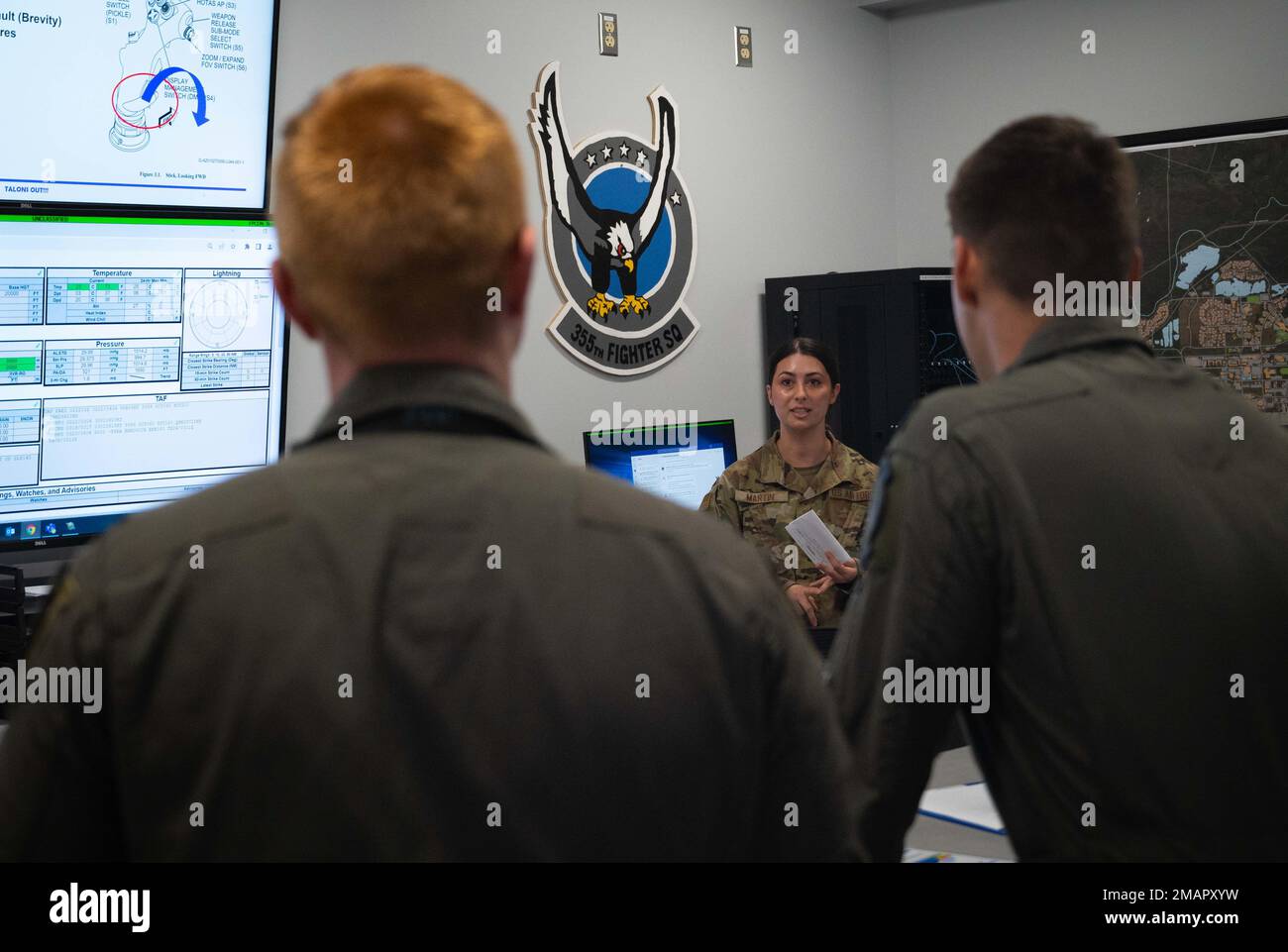 U.S. Air Force Staff Sgt. Amber Martin, 354th Operations Support Squadron weather operations journeyman, gives a mission execution forecast briefing to 354th Fighter Squadron pilots at Eielson Air Force Base, Alaska, June 02, 2022.  An MEF holds a plethora of aviation-related weather information in a concise and easily readable format to quickly communicate to pilots potential weather impacts to their operations. Stock Photo