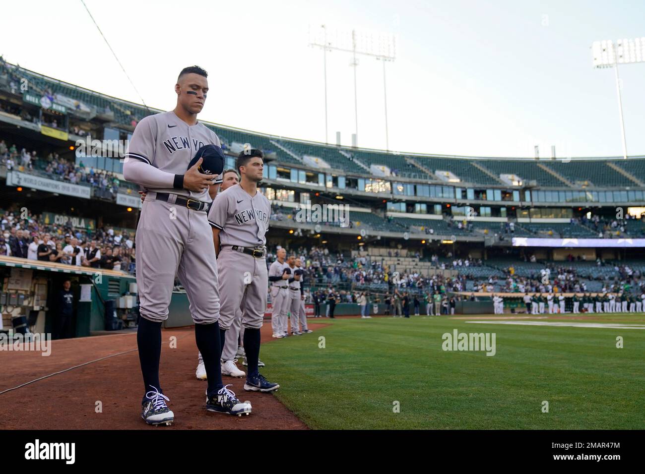 New York Yankees Aaron Judge, left, and teammates listen to the national anthem before a baseball game against the Oakland Athletics in Oakland, Calif., Thursday, Aug. 25, 2022