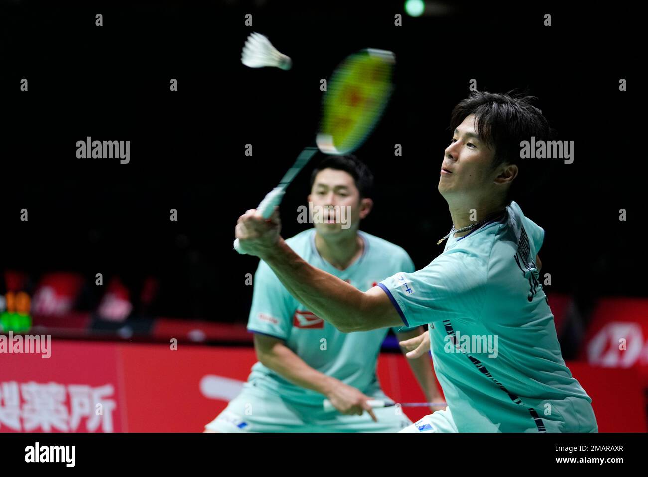 Yugo Kobayashi, with Takuro Hoki of Japan, plays a return during a badminton game of the mens doubles against Alexander Dunn and Adam Hall of Scotland in the BWF World Championships in