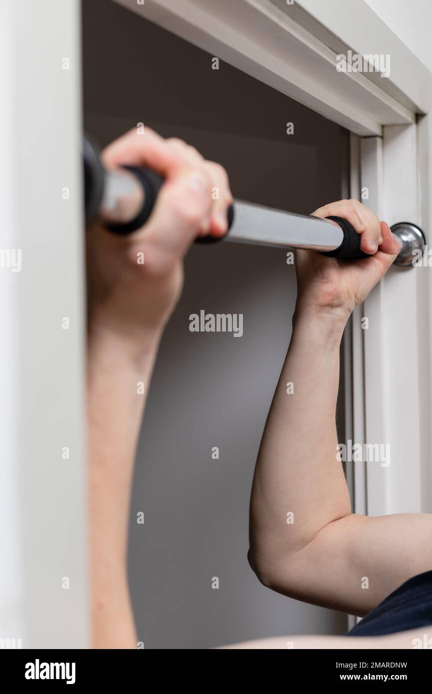 Pull up bar in home in a doors frame fitness at home vertical photo