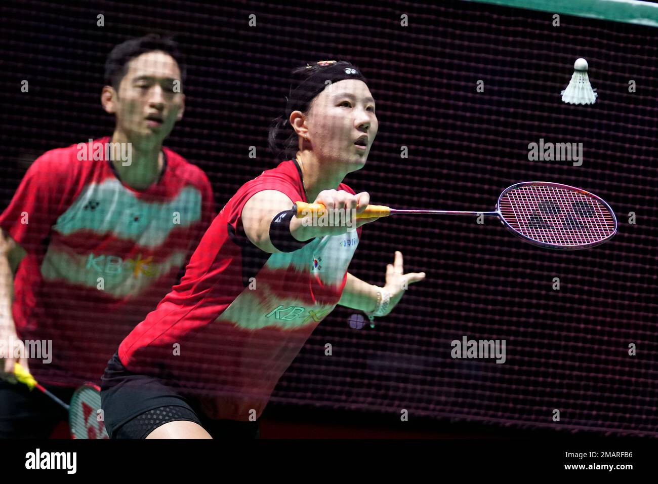 Shin Seung-chan of South Korea, with Choi Sol-gyu, plays a return during a  badminton game of the mixed doubles against Dechapol Puavaranukroh and  Sapsiree Taerattanachai of Thailand in the BWF World Championships