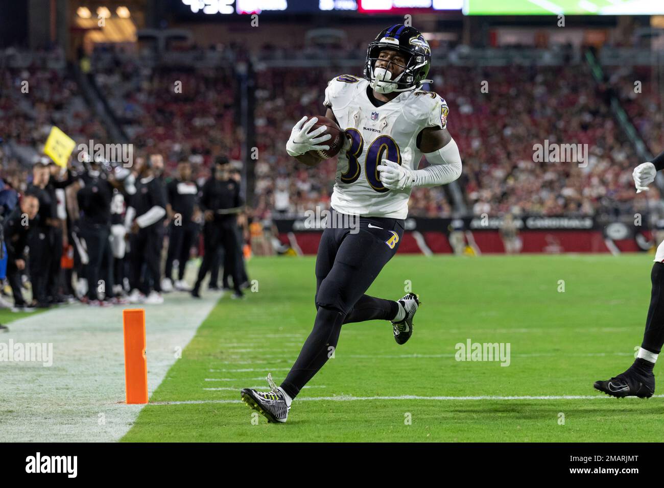 Running back (30) Tyler Badie of the Baltimore Ravens catches a pass and  runs for a touchdown against the Arizona Cardinals in an NFL preseason  football game, Sunday, Aug. 21, 2022, in