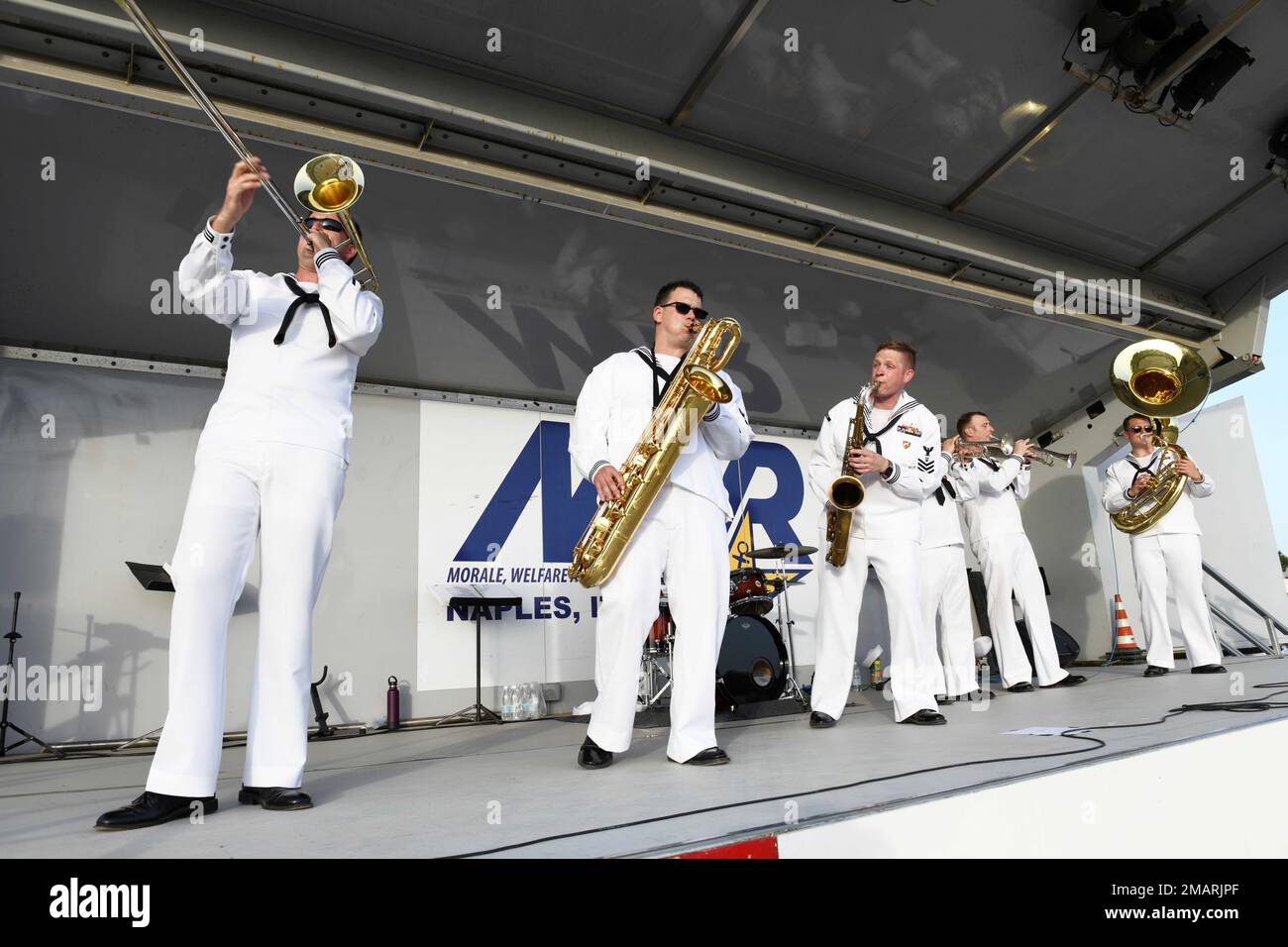 220603-N-IE405-3672 NAPLES, Italy (June 3, 2022) The U.S. Naval Forces Europe and Africa Band members perform 'Anchors Aweigh' during a concert to commemorate the 80th anniversary of the Battle of Midway onboard NSA Naples’ Support Site in Gricignano di Aversa, Italy, June 3, 2022. NSA Naples is an operational ashore base that enables U.S., allied, and partner nation forces to be where they are needed, when they are needed to ensure security and stability in the European, African, and Central Command areas of responsibility. Stock Photo