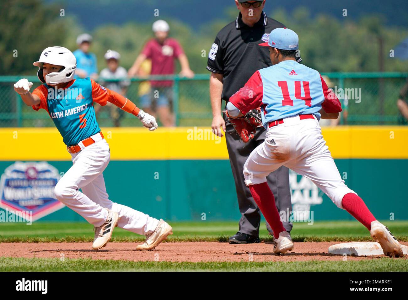 Nicaragua's Erik Gonzalez (5) attempts to advance to third base after over  running second base advancing on a passed ball as Panama shortstop Jeykol  de Leon (14) looks to tag him and