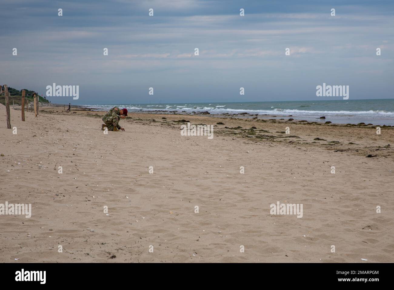 Soldier collects Sand at Utah Beach during the D Day commemorations in