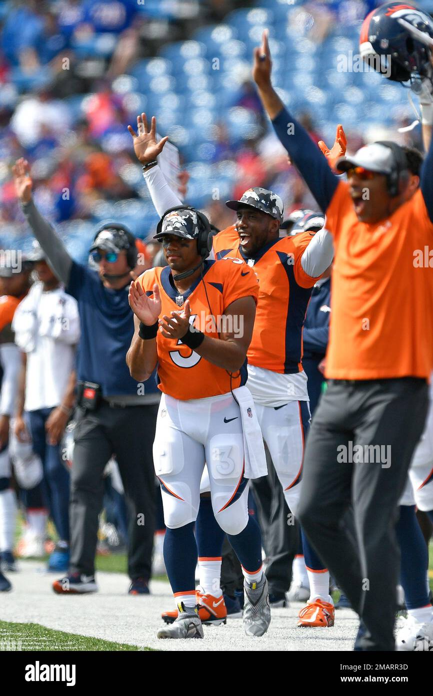 Denver Broncos quarterback Russell Wilson celebrates on the sideline ...