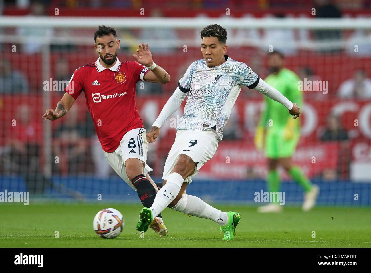 Manchester United S Bruno Fernandes Left Challenges For The Ball With Liverpool S Roberto Firmino During The English Premier League Soccer Match Between Manchester United And Liverpool At Old Trafford Stadium In Manchester England