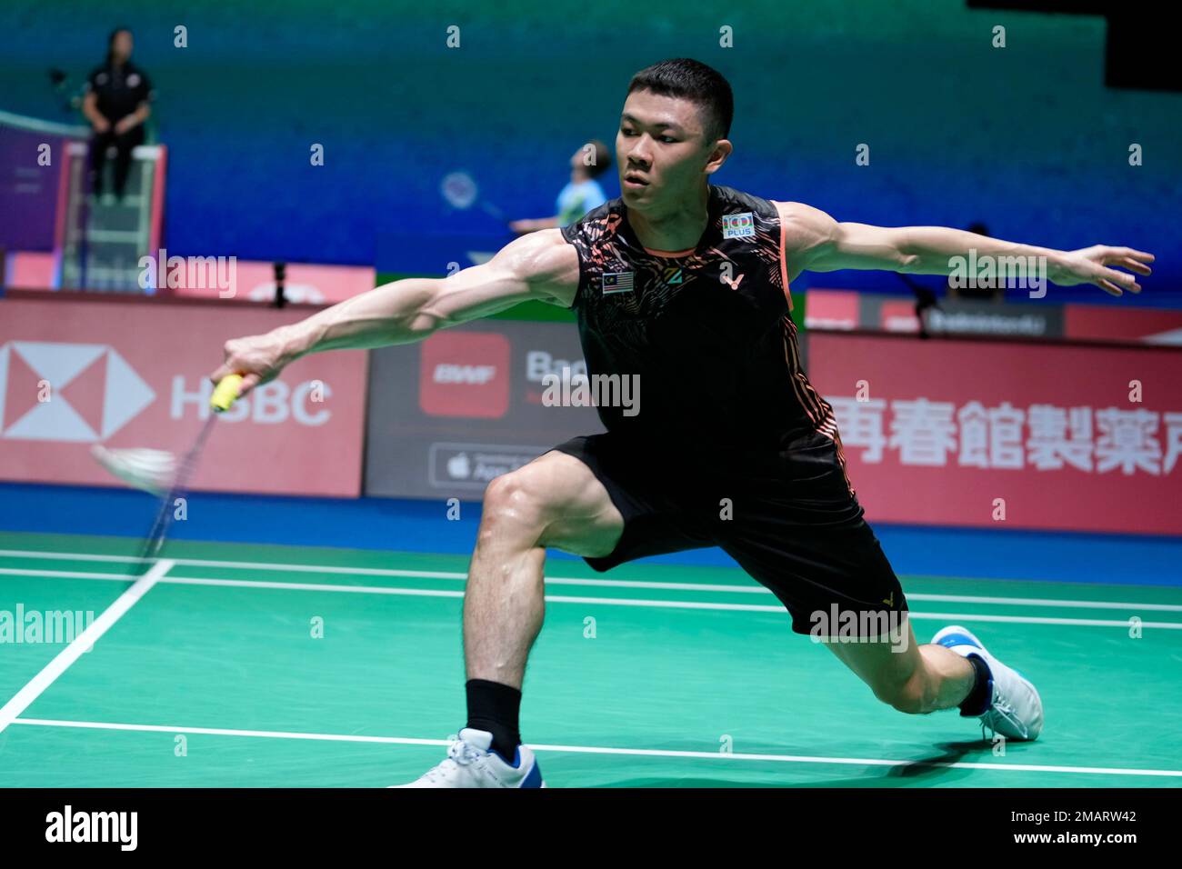 Lee Zii Jia of Malaysia plays a return against Brice Leverdez of France during a badminton game of the mens singles in the BWF World Championships in Tokyo, Monday, Aug