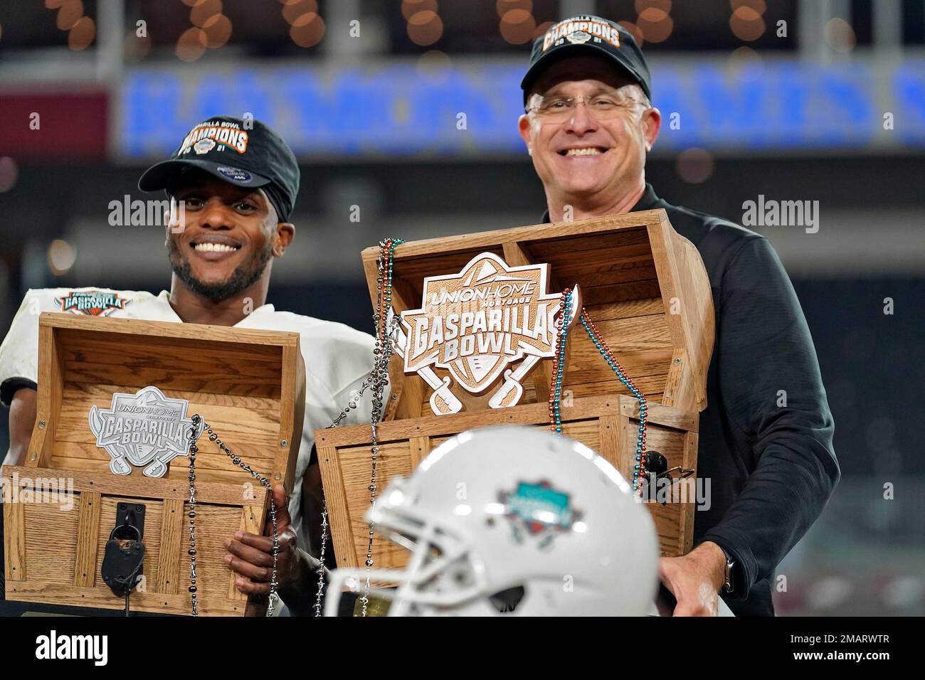 FILE - Central Florida wide receiver Ryan O'Keefe, left, and head coach Gus  Matzahn holds up their trophies after winning the Gasparilla Bowl NCAA  college football game against Florida Thursday, Dec. 23,