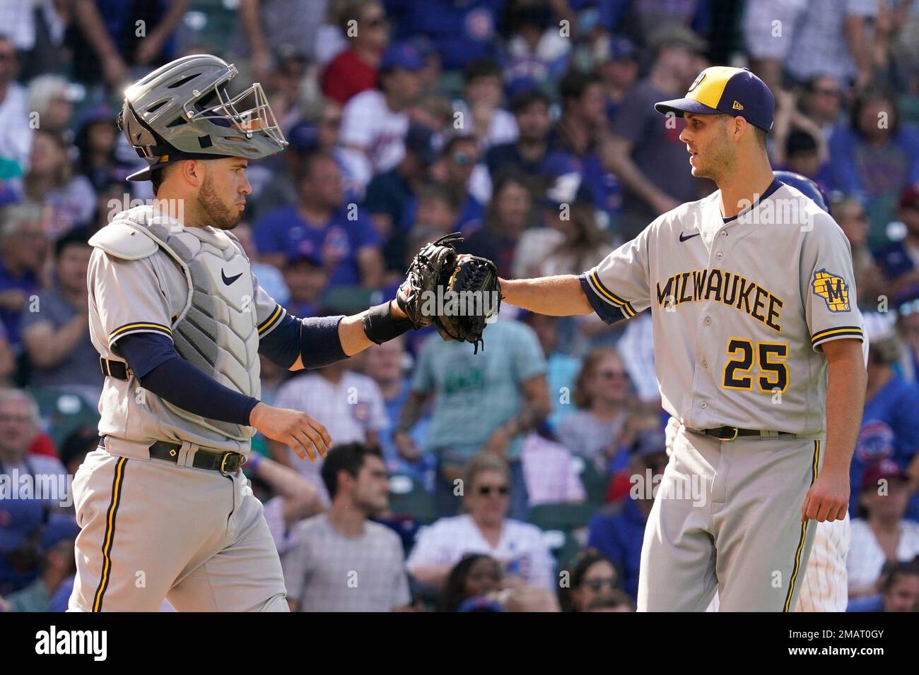 Milwaukee Brewers catcher Victor Caratini, left, celebrates with relief