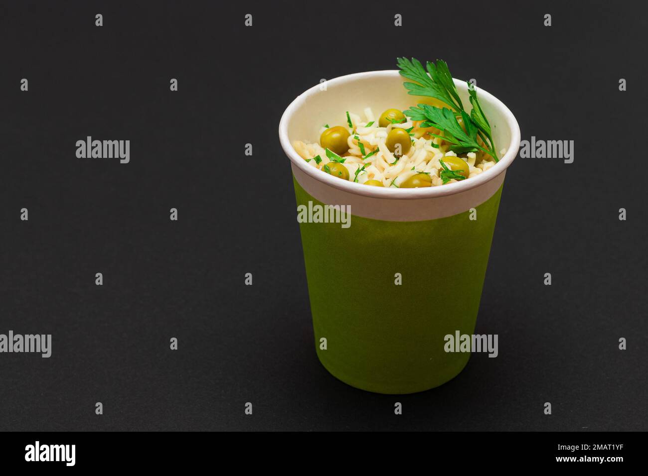 Prepared Instant Noodles with Green Pea and Greens in Green Cup on