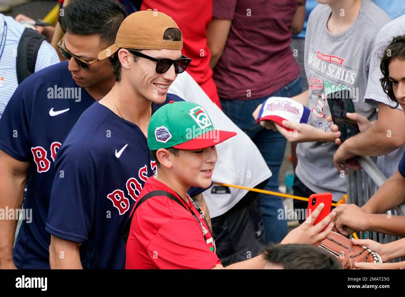 Boston Red Sox's Jarren Duran has his photo taken with a member of the  Mexico Little League team as the Red Sox arrive at the Little League World  Series tournament in South