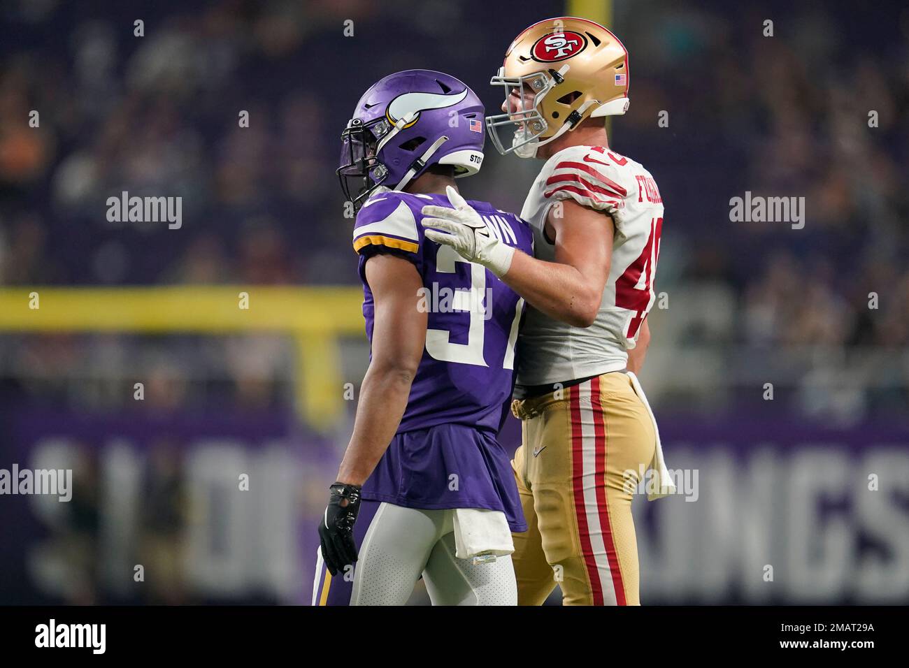 Minnesota Vikings safety Mike Brown (37) and San Francisco 49ers tight end  Troy Fumagalli (49) embrace during the second half of an NFL preseason  football game Saturday, Aug. 20, 2022, in Minneapolis. (