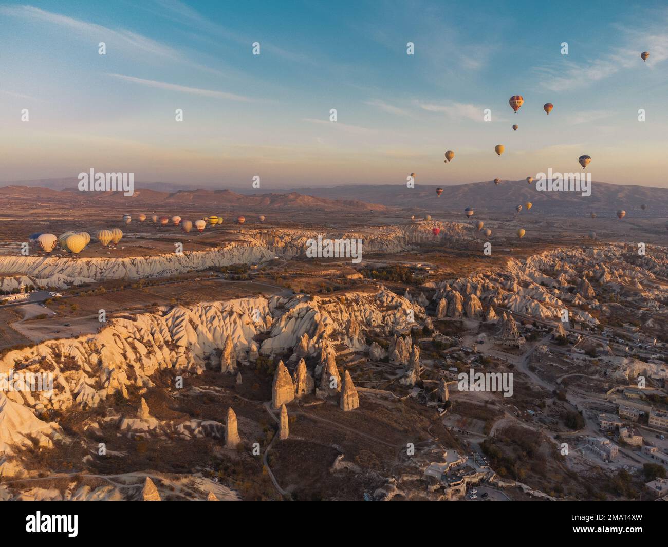 hot air balloons at fairy chimneys at sunrise in G reme, Cappadocia. Turkey Stock Photo
