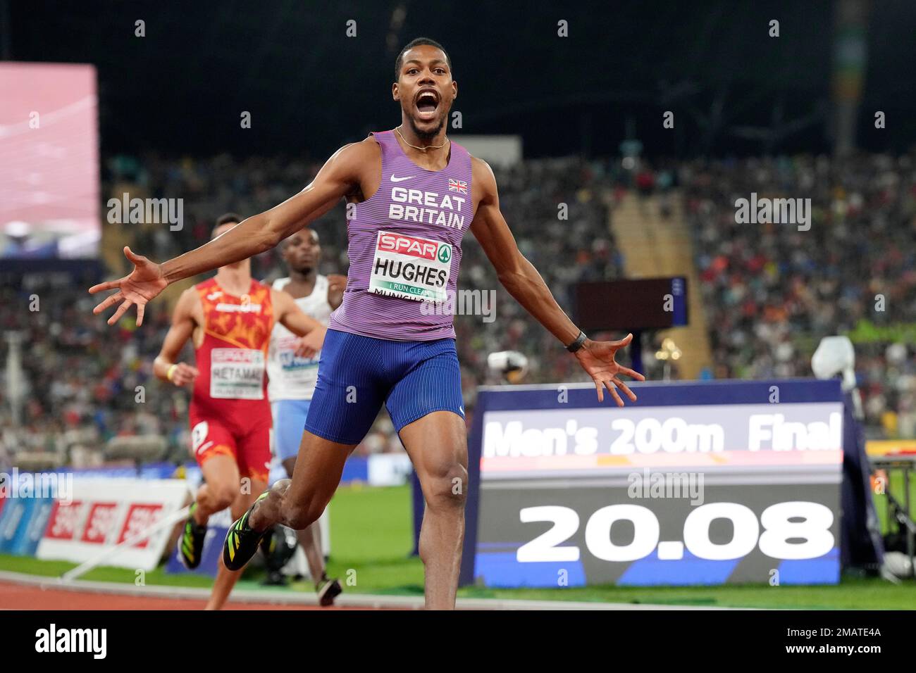 Zharnel Hughes, of Great Britain, celebrates after winning the gold