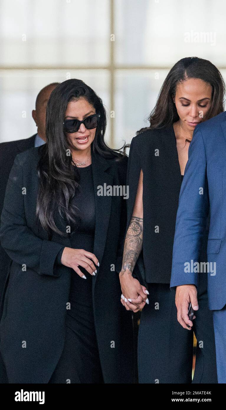 Vanessa Bryant, left, the widow of the late Kobe Bryant, holds hands