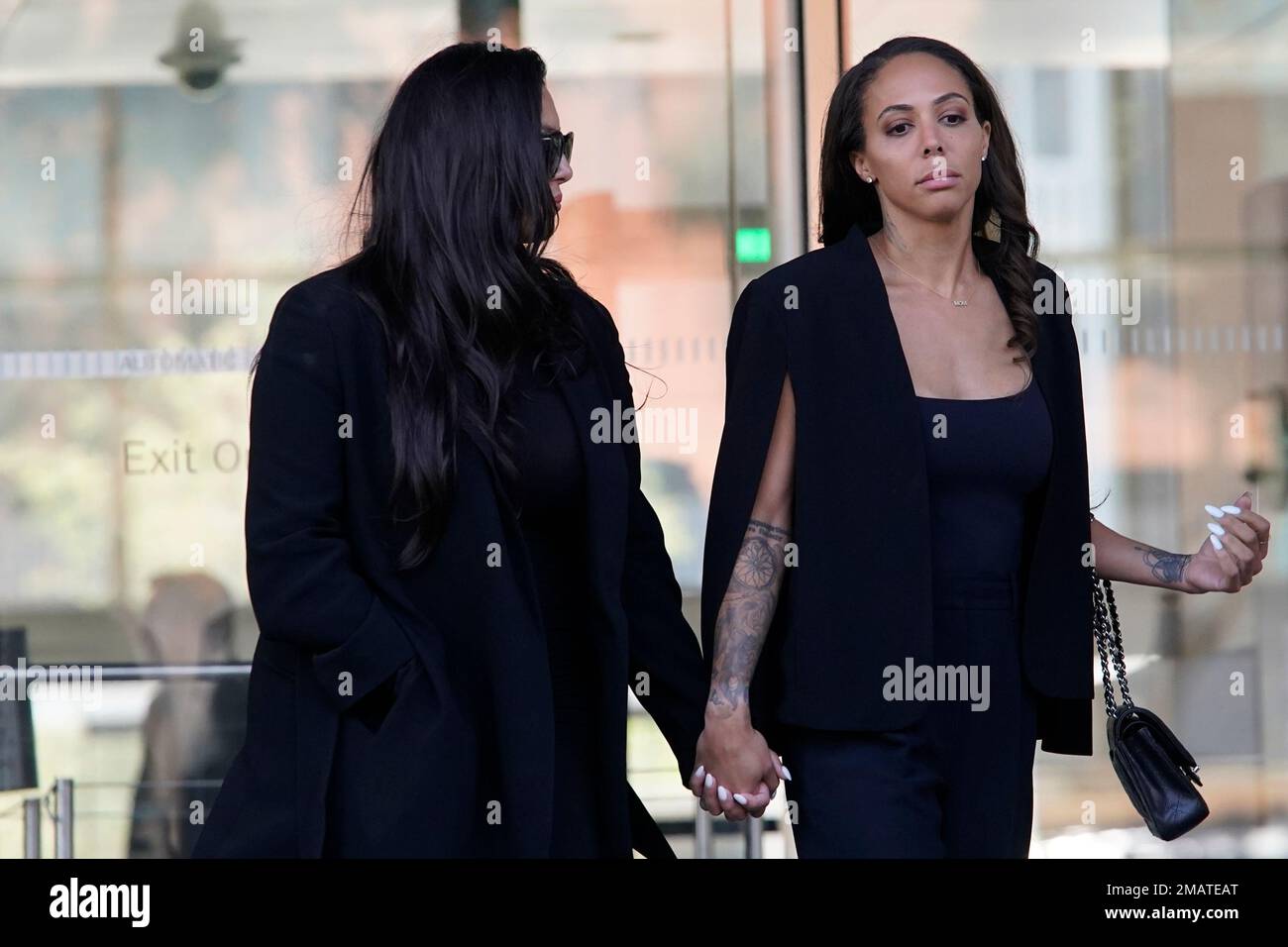 Vanessa Bryant, left, the widow of the late Kobe Bryant, holds hands