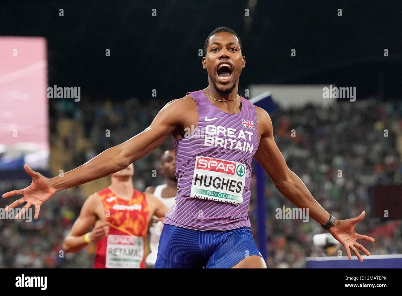 Zharnel Hughes, of Great Britain, celebrates after winning the gold