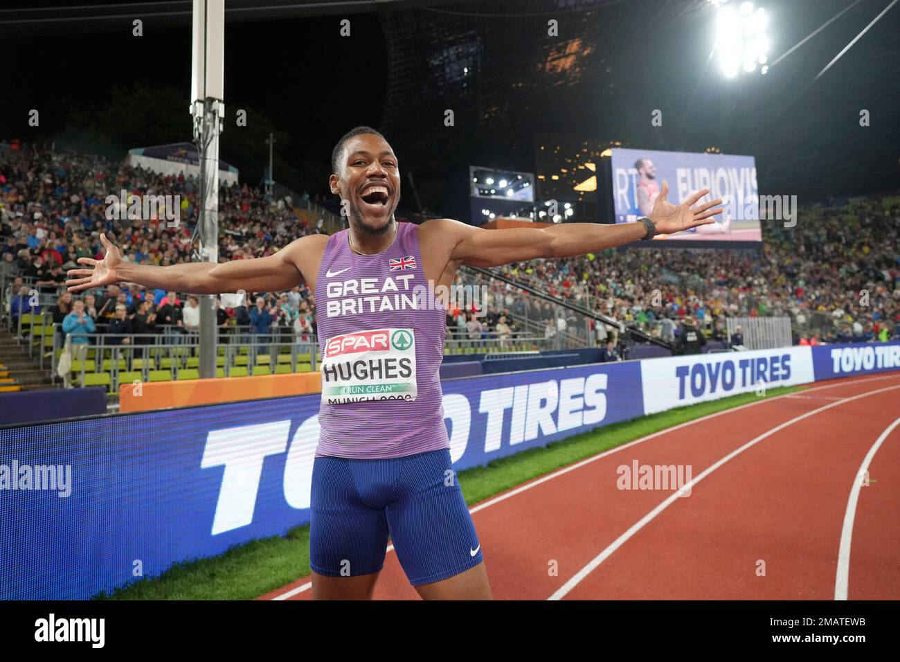 Zharnel Hughes, of Great Britain, celebrates after winning the gold