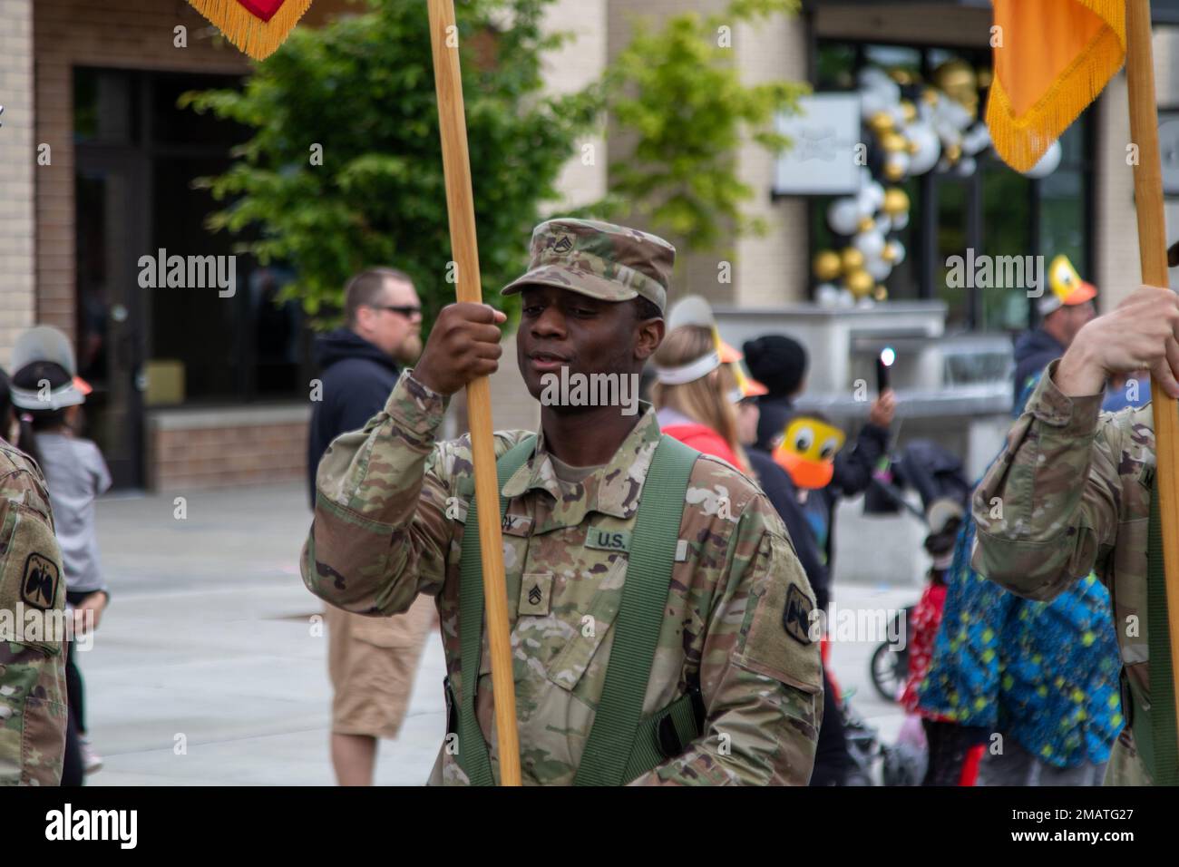 The Color Guard, assigned to 46th Aviation Support Battalion, 16th Combat Aviation Brigade, marches in the 'Duck Daze' parade at University Place, Wash. on Jun. 4, 2022. Stock Photo