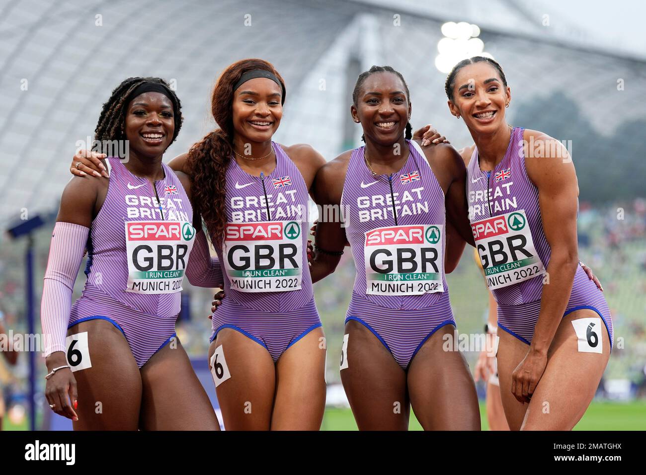 The team of Great Britain poses after winning their Women's 4x100