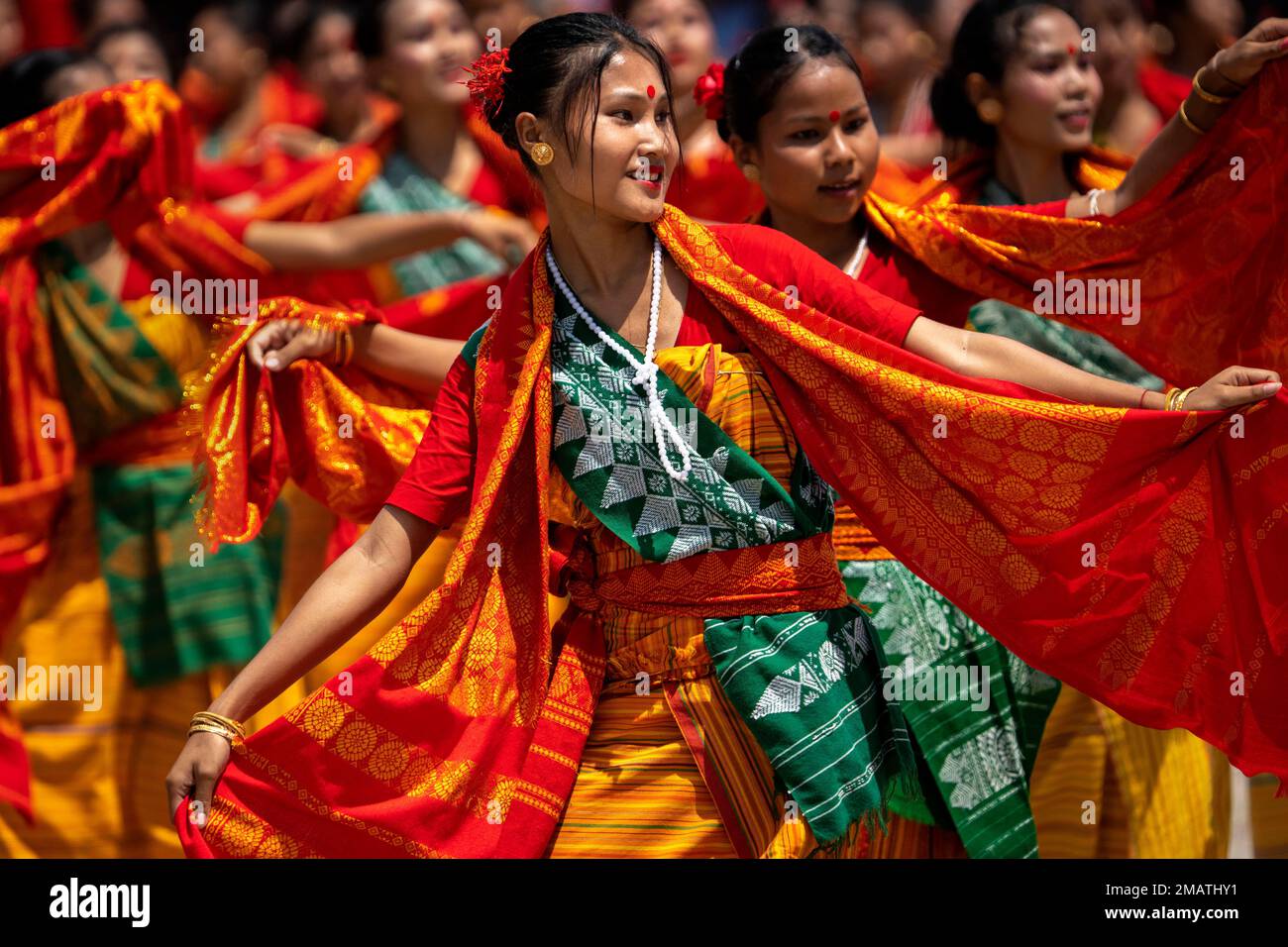 Tribal Bodo girls in traditional attire perform Sikhlai dance on