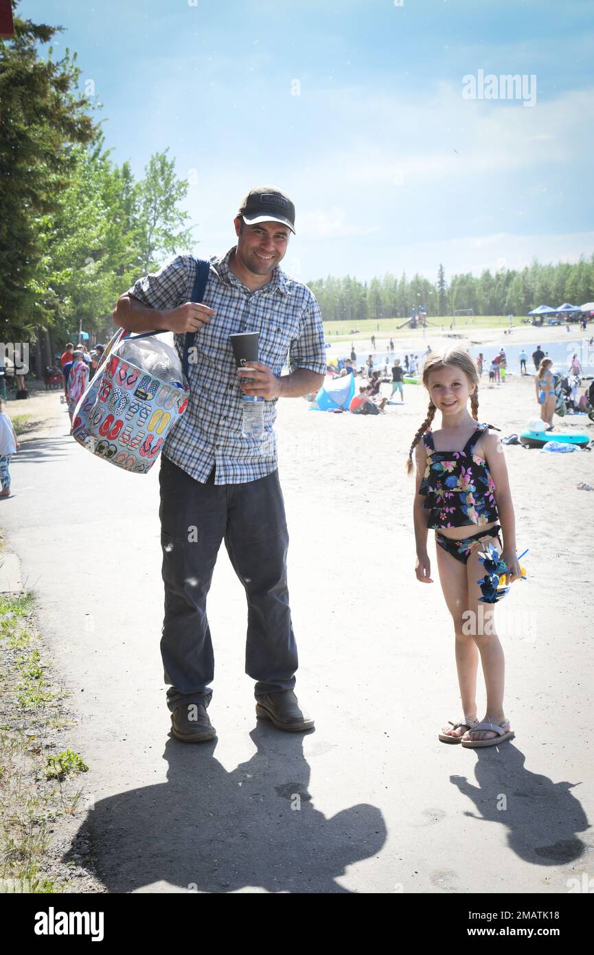 Senior Master Sgt. James Hudnall of the 168th Wing takes a photo with his daughter during the 168th Wing family day at Chena Lakes, North Pole, Alaska, June 4, 2022. Hudnall serves as a boom operator on the  KC-135th Stratoranker. A Family Day picnic is a tradition for the 168th Wing to get together and spend time with each other along with each other’s families. Stock Photo