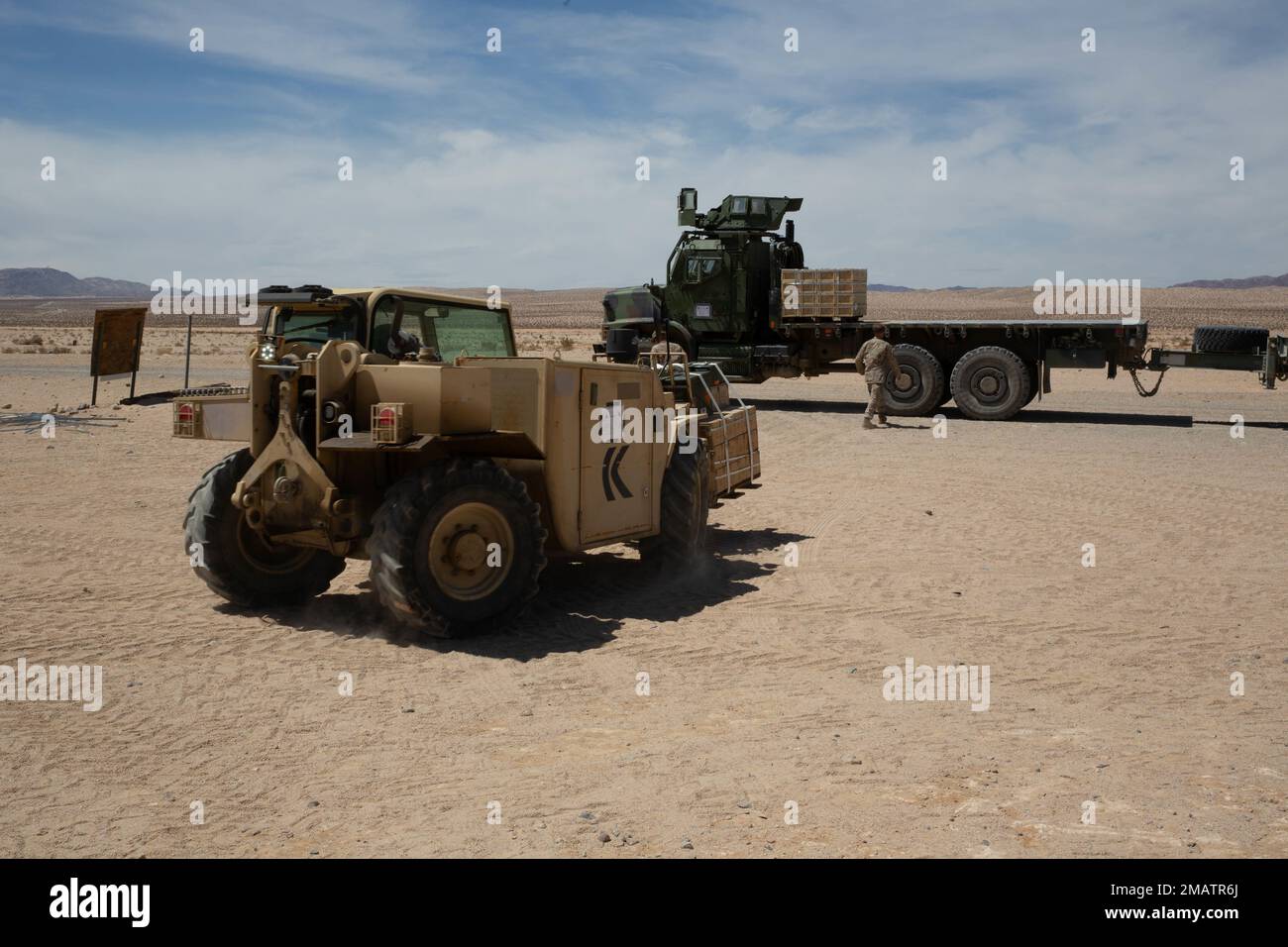 U.S. Marines with Combat Logistics Battalion 13, 13th Marine Expeditionary Unit, load ammunition onto a Medium Tactical Vehicle Replacement utilizing a Rough Terrain Forklift during Realistic Urban Training exercise at Marine Corp Air Ground Combat Center Twentynine Palms on June 4, 2022. The 13th MEU is currently conducting RUT exercise to enhance the integration and collective capability of the MEU’s command, air, ground, and logistics elements and prepare the 13th MEU to meet the nation’s crisis response needs during their upcoming overseas deployment. Stock Photo