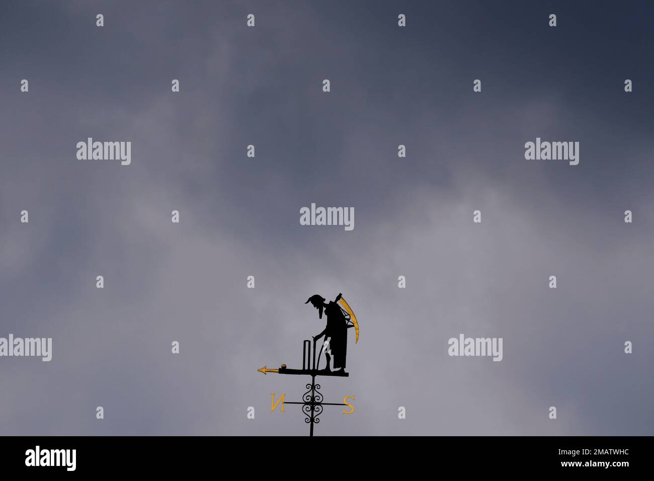 Dark clouds over the Father Time weathervane during the first day of