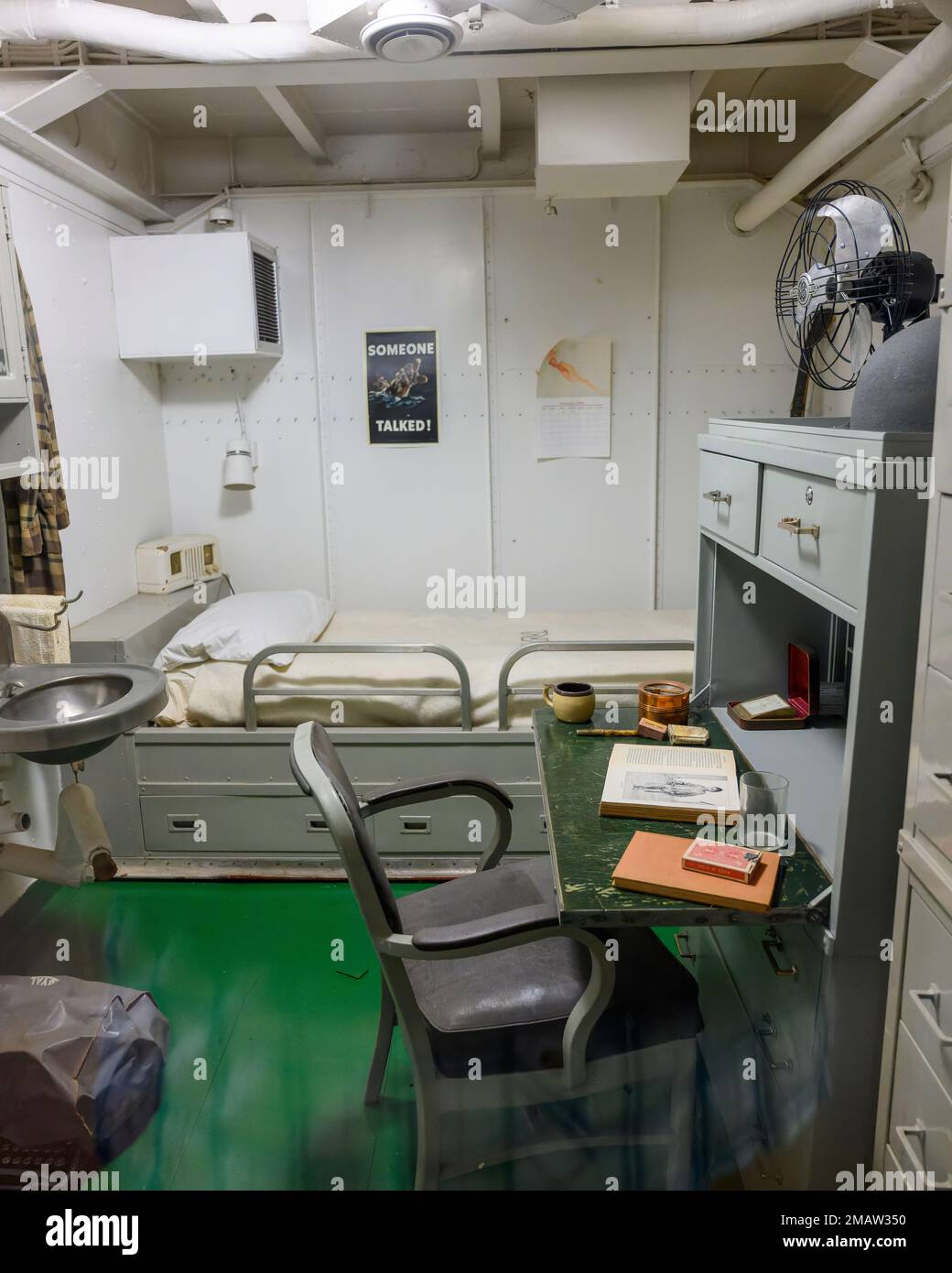 Captain's quarters or state room for the captain of the USS Alabama battleship showing a writing desk, bunk and sink in a small space. Stock Photo